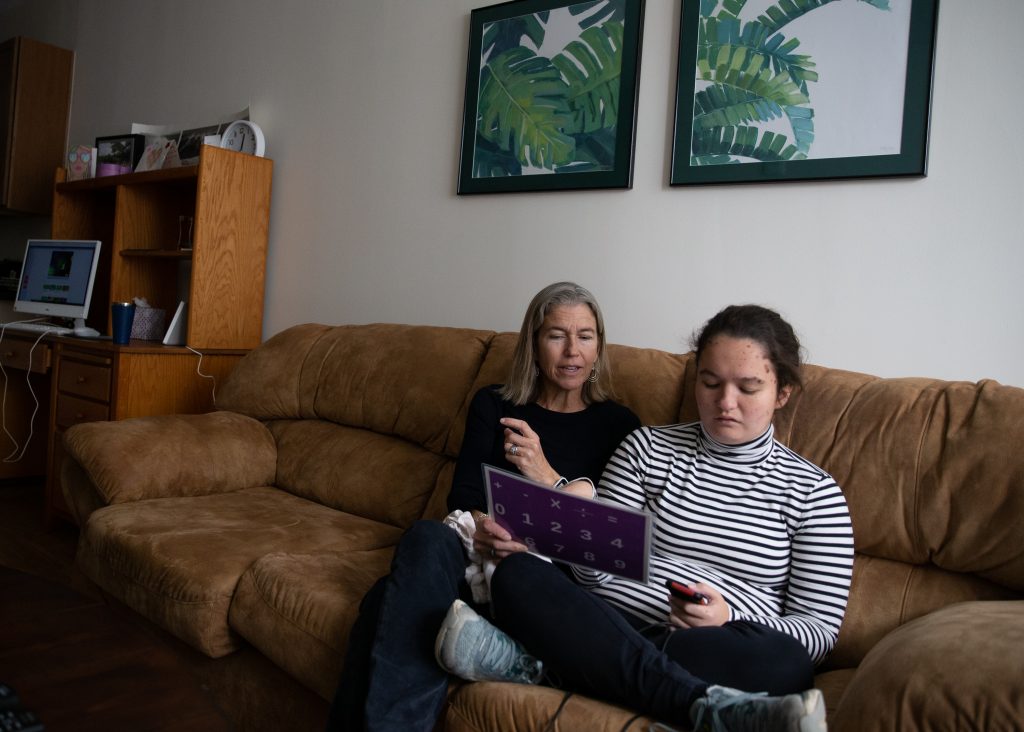 Donna Budway sits with her daughter Emma in Emma's apartment at Gilliam Place.